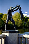 Oslo, Norway. Vigeland Park. Sculptures of the bridge, Man swinging a boy.